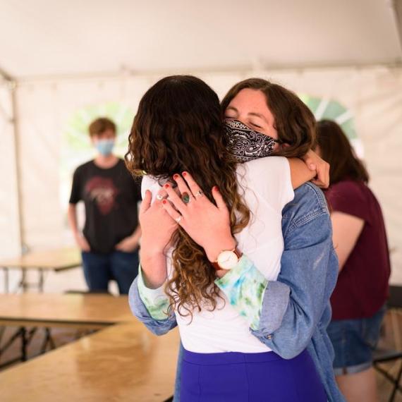 Returning to campus, hugging in reunion